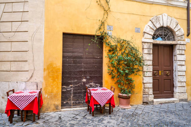 A narrow, cobbled alleyway in Rome with a simple, unmarked doorway, hinting at a hidden restaurant